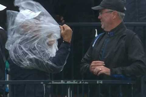 Hilarious moment as spectator at The Open gets trapped inside his own PONCHO during strong winds at ..