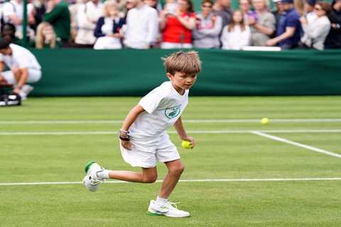 Reigning champ Novak Djokovic practices with his young son on his first day of Wimbledon